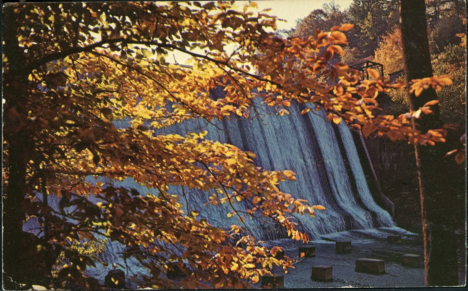 The falls at Gorge Park, Cuyahoga Falls, water running over dark rock ledges under autumn trees