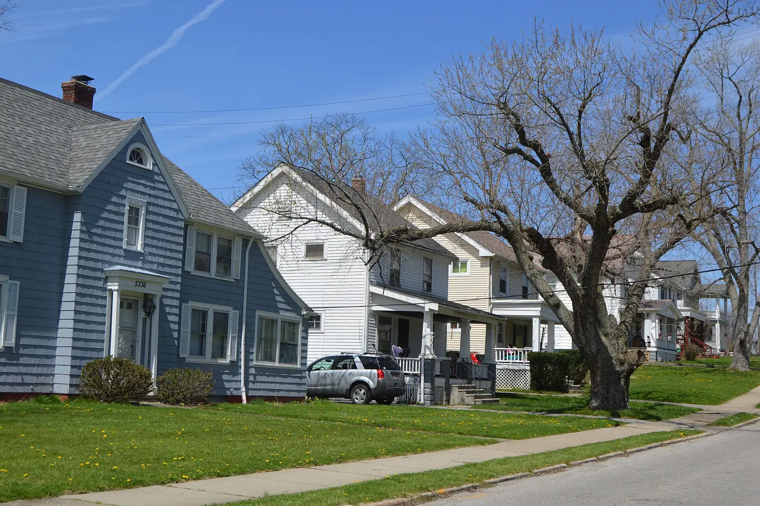 A residential street in Maple Heights: post-war houses with front porches and mature street trees along Vine Street